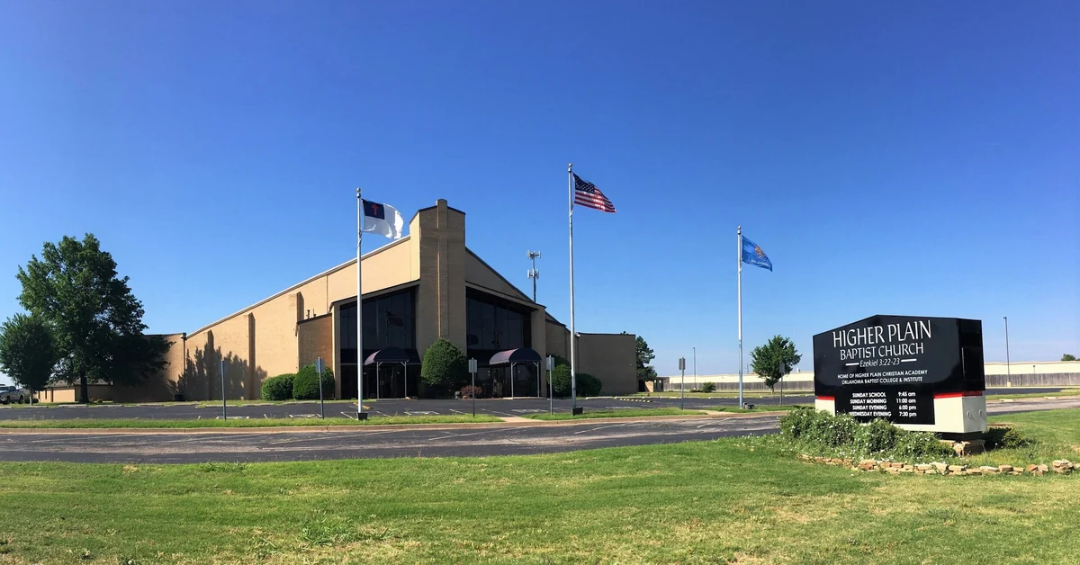 Higher Plain Baptist Church and its roadside sign under a clear Oklahoma sky